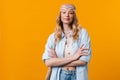 Young blonde woman wearing bandanna posing and looking at camera