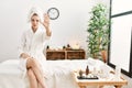 Young blonde woman wearing bathrobe at wellbeing spa doing stop sing with palm of the hand Royalty Free Stock Photo