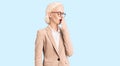 Young blonde woman wearing business clothes and glasses bored yawning tired covering mouth with hand Royalty Free Stock Photo
