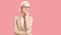 Young blonde woman wearing business clothes and glasses looking confident at the camera with smile with crossed arms and hand Royalty Free Stock Photo
