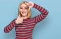 Young blonde woman wearing casual clothes smiling making frame with hands and fingers with happy face Royalty Free Stock Photo