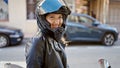 Young blonde woman wearing motorcycle helmet smiling at street Royalty Free Stock Photo