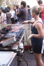 Young blonde woman working a hot grill Royalty Free Stock Photo