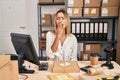 Young blonde woman working at small business ecommerce bored yawning tired covering mouth with hand Royalty Free Stock Photo