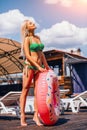 Young Blondie Woman Is Holding An Inflatable Swim Ring While Standing Near The Pool. Royalty Free Stock Photo