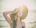 Young blondy girl in sunglasses and straw hat at the beach Royalty Free Stock Photo