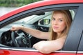 Young blue-eyed blonde looks through the car window Royalty Free Stock Photo