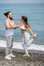 Couple stretching on beach Royalty Free Stock Photo