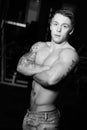 Young bodybuilder posing in jeans Royalty Free Stock Photo