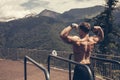 Young bodybuilder showing muscles shape outdoors Royalty Free Stock Photo