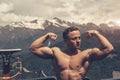 Young bodybuilder showing muscles shape outdoors Royalty Free Stock Photo