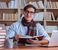 Young book writer writing in library Royalty Free Stock Photo