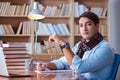 The young book writer writing in library Royalty Free Stock Photo