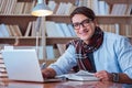 The young book writer writing in library Royalty Free Stock Photo