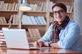 The young book writer writing in library