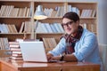 The young book writer writing in library Royalty Free Stock Photo