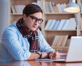 Young book writer writing in library