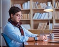 Young book writer writing in library