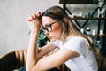 Young bored millennial woman sitting on a sofa alone at home. Fatigue or emotionally exhausted concept Royalty Free Stock Photo