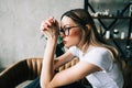 Young bored millennial woman sitting on a sofa alone at home. Fatigue or emotionally exhausted concept Royalty Free Stock Photo