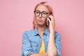 Young bored woman talking on the phone waiting for answer on call centre. Royalty Free Stock Photo