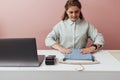 Young boutique owner straightens clothes on counter