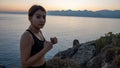 Young boxer girl posing by the sea over huge cliffs at sunset. She wears tights and sports bra Royalty Free Stock Photo