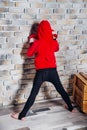 Little boy boxer with blonde hair dressing in red sweatshirt wearing boxing gloves posing in a studio. Royalty Free Stock Photo