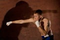 Young boxer punching an opponent