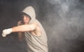 Young boxer throwing his weight behind a punch