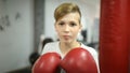 Boy boxing with gloves in the gym