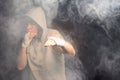 Young boxer working out in a smoky room