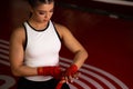 Young boxing woman binds the bandage on hand before training Royalty Free Stock Photo