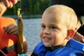 A young boy admires the sunfish he caught Royalty Free Stock Photo