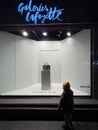 young boy admiring the showcase window of Galeries Lafayette with Prada leather Royalty Free Stock Photo