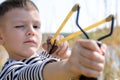 Young Boy Aiming Sling Shot at Camera Royalty Free Stock Photo