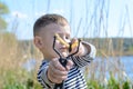 Young Boy Aiming Sling Shot at Camera Royalty Free Stock Photo