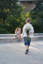 A young boy is approaching to the girl with flowers Royalty Free Stock Photo