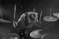 Young boy as rock band drummer . Handsome and cool Asian American teenager in headband playing drum kit performing night music Royalty Free Stock Photo