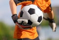 Young boy as a soccer goalie holding the ball in one hand ready to start a game Royalty Free Stock Photo