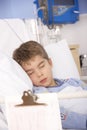 Young boy asleep in hospital bed Royalty Free Stock Photo