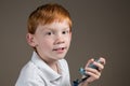 Young boy with asthma holding an inhaler Royalty Free Stock Photo