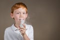 Young boy with asthma undergoing a breathing treatment