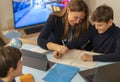 Young boy attends an online classes with parental support