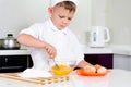 Young boy baking whipping eggs Royalty Free Stock Photo