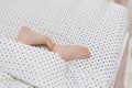 Child bare feet bed under blanket Royalty Free Stock Photo