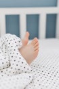 Child bare feet bed under blanket Royalty Free Stock Photo