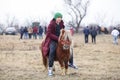 Young boy is bareback riding a pony before an Epiphany celebration horse race