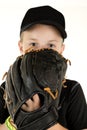 Young boy baseball pitcher peering over glove ready to pitch