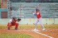 a child getting ready to bat at a baseball game with catcher and umpire Royalty Free Stock Photo